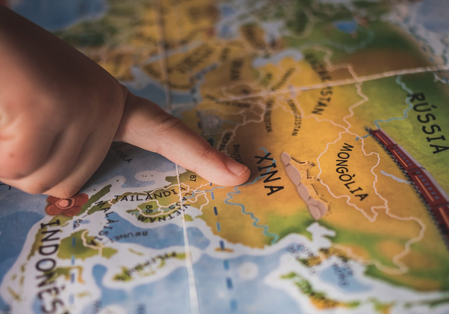 Photo by Xavi Cabrera person holding yellow and green map